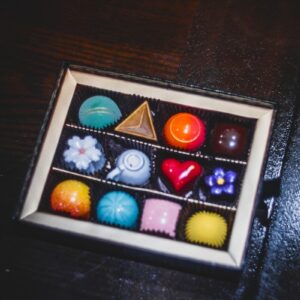 A box of assorted colorful gourmet chocolates.